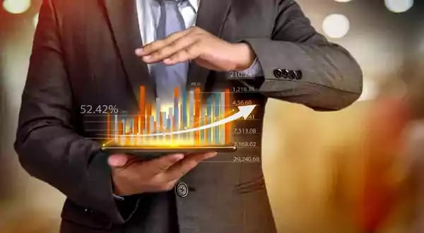Man holding a model of a bar graph.