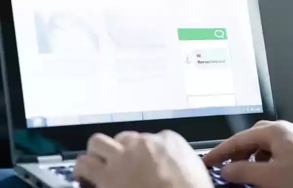 Typing on a laptop computer.