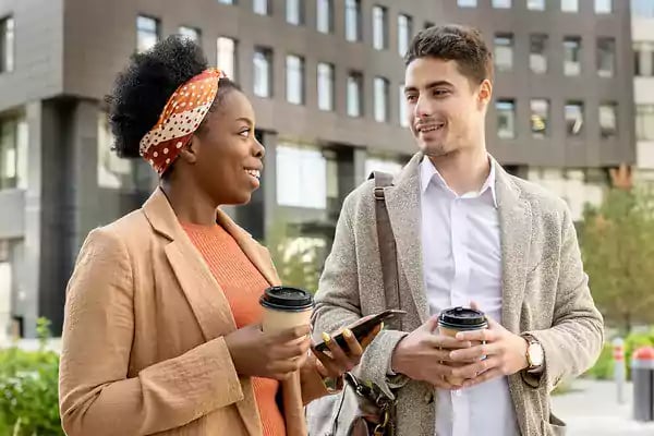 Two people drinking coffee and talking.
