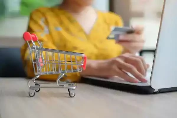 Minature shopping cart on a table top.