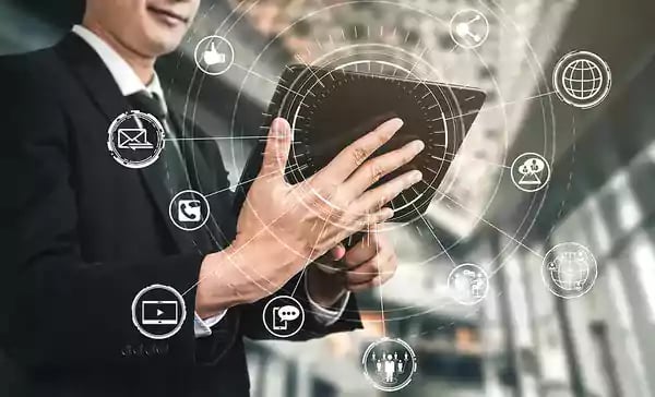 Man in a business suit looking at a tablet.