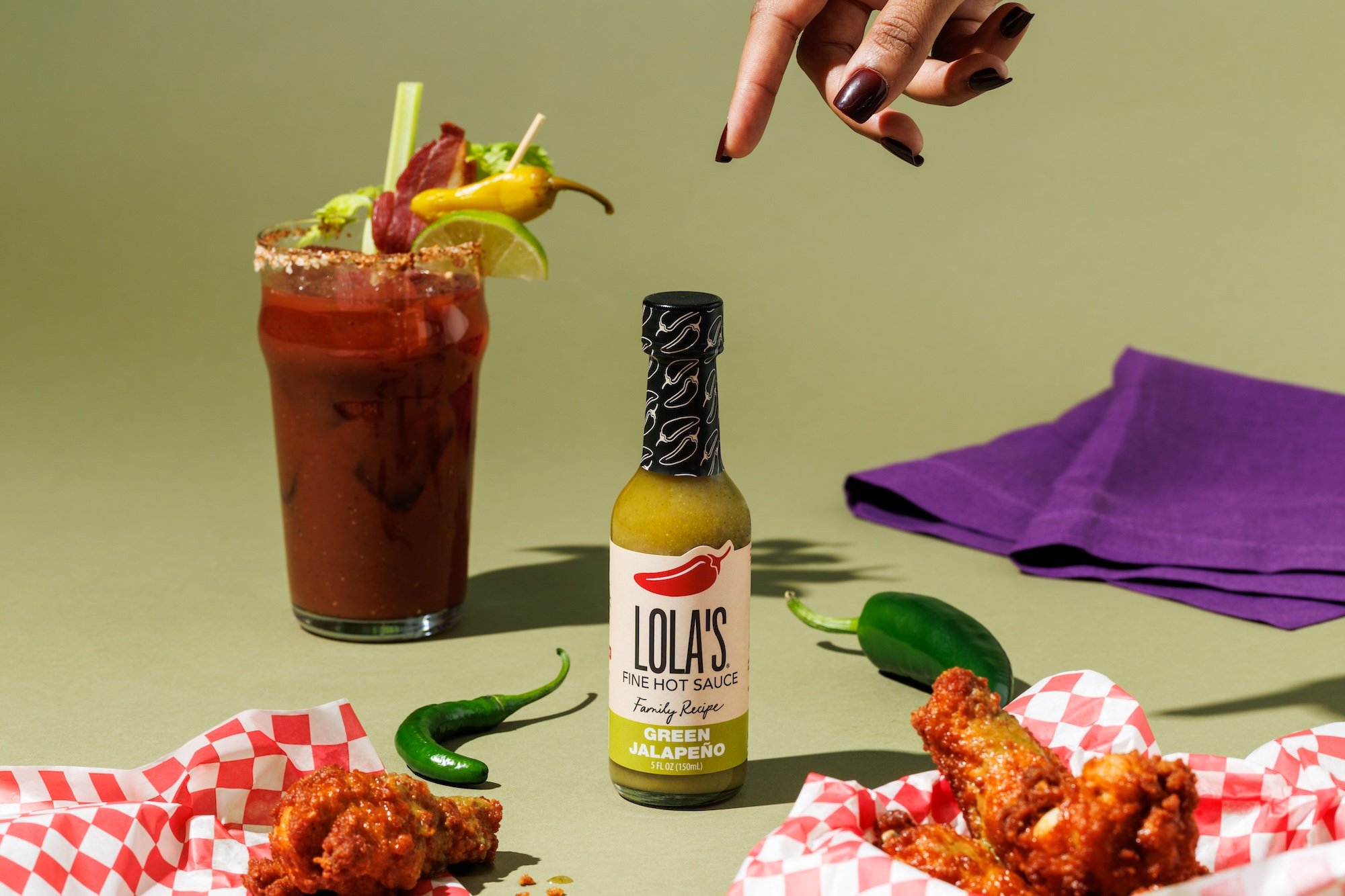 Lola’s Green Jalapeño hot sauce with a Bloody Mary and chicken wings